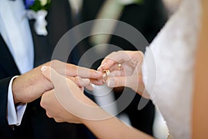 Bride putting wedding ring