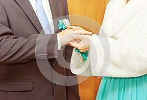 Bride putting a wedding ring