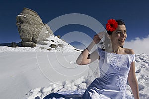 Bride with red flower in hair.