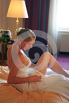 Bride relaxing on bed