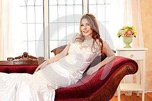 Bride relaxing on fainting couch photo