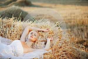 Bride resting in hay stack