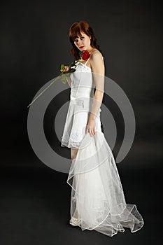 Bride with rose and veil on black background