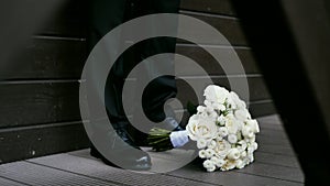 Bride's bouquet between the groom's shoes for the wedding