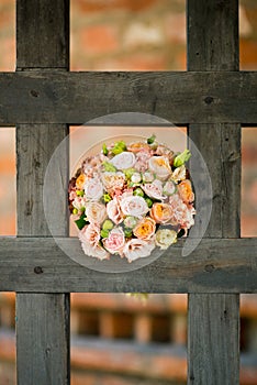 The bride s bouquet lies in the cell of a large wooden lattice, which is the gateway to the ancient church