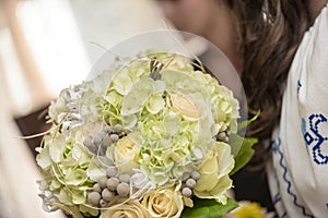 Bride's bouquet with white roses, hydrangea, green leaves