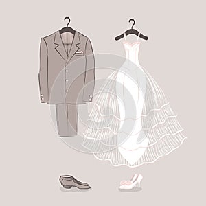 Bride's dress and groom's suit on hangers
