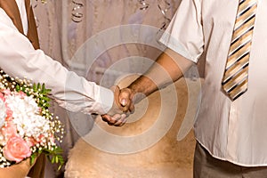 The bride`s father shakes hands with his son-in-law.
