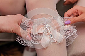 Bride& x27;s garter on the bride& x27;s leg. Garter on the girl& x27;s leg. morning of the bride