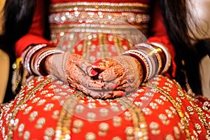 Bride's hand with henna and bangles, punjabi wedding photo