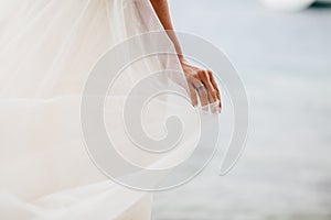 Bride`s hand with ring and veil