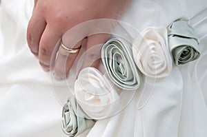 Bride's hand wearing wedding ring photo