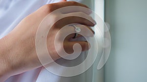 Bride's hand with wedding ring close up white dress. Preparation of the bride, Morning of the bride.