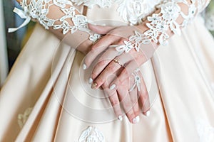 Bride`s hands in dress with ring