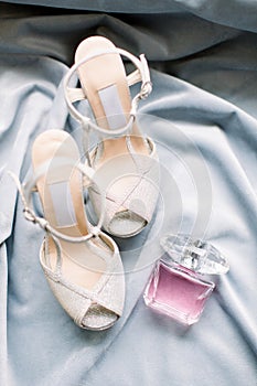 The bride`s shoes and perfume. Preparations for the wedding day.
