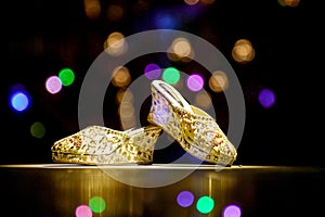 Bride sandal with reflection colourful bokeh