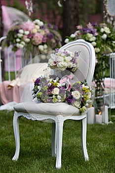 Bride set of bouquet on the vintage chair in the forest