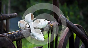 Bride shoes on rustic car