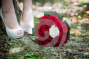 Bride shoes with wedding bouquet