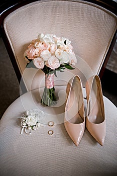 Bride shoes with wedding gold rings and bouquet