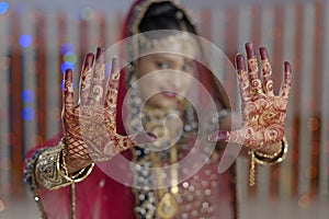 Bride showing henna on her hands hands in Indian Hindu wedding