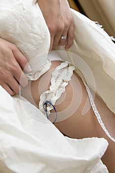 Bride showing her leg with garter