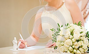 Bride  signing marriage wedding certificate at registry