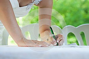 Bride signs at her wedding