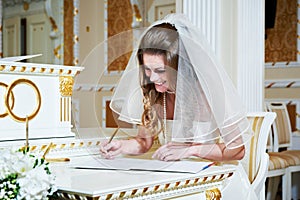 Bride signs on solemn registration of marriage