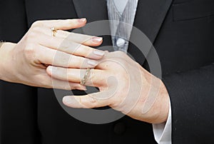 Bride slipping ring on finger