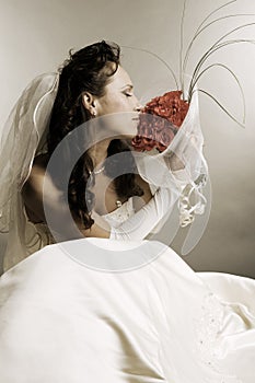 Bride smelling the fragrance of roses