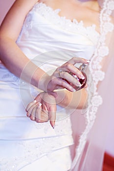 Bride spraying perfume