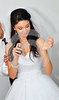 Bride spraying perfume