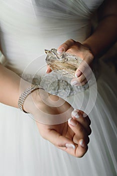 Bride squirting perfume, close-up