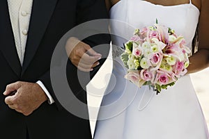 Bride Standing Arm In Arm With Father