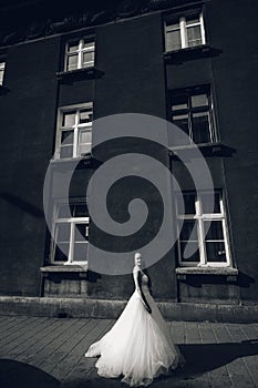 The bride is standing in front of the building