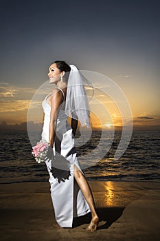 Bride standing holding bouquet