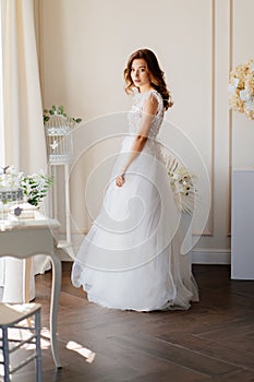 Bride in stands near wall waiting of ceremony