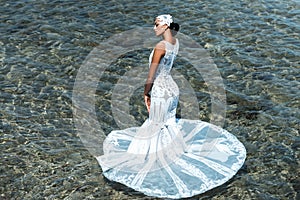 Bride on sunny summer day on seascape