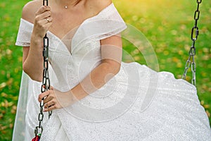 Bride on a swing close-up without a face