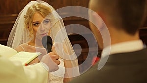 Bride taking wedding vows in church