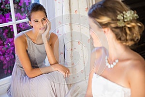 Bride talking to bridesmaid at home