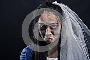 Bride with tear-stained face on black background