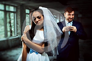 Bride with tearful face and groom with sly smile