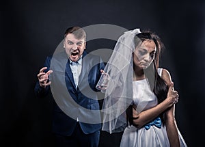 Bride with tearful face and terrible brutal groom