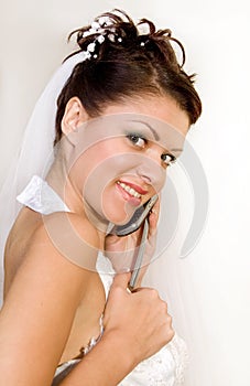 Bride with telephone on a white background