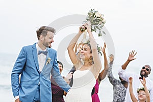 Bride throwing flower bouquet to guests