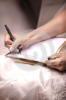 Bride to be writing her vows to her husband to be before the wedding ceremony