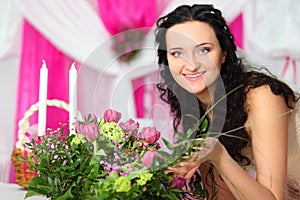 Bride touches beautiful bouquet of pink tulips
