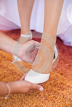 Bride try white wedding shoes